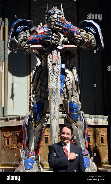 Canadian Voice Actor Peter Cullen Participates In A Handprint Ceremony Beside Optimus Prime From