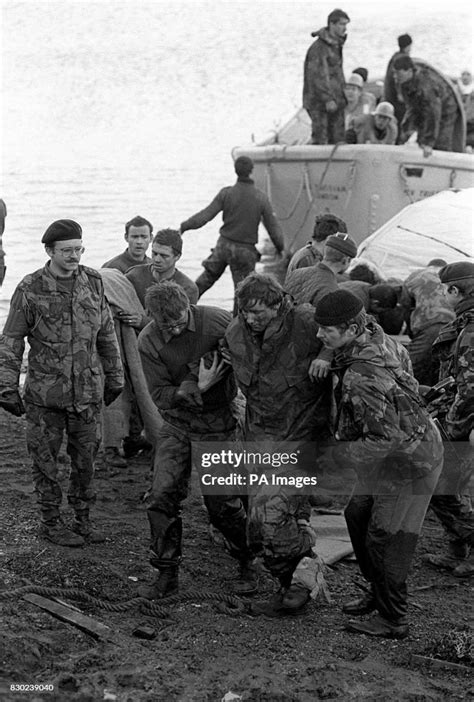 The Falklands War Aid For An Injured Companion As Survivors Come Ashore At Bluff Cove East