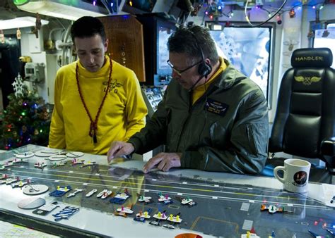 Us Navy 111215 N Bt887 008 Flight Deck Handler Lt Cmdr Edward Jaso Maps Out Aircraft Placement